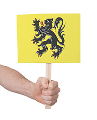 Image showing Hand holding small card - Flag of Flanders