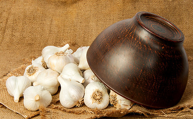 Image showing Garlic spill out of a ceramic bowl