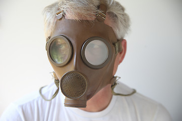 Image showing old gas mask worn by senior man 