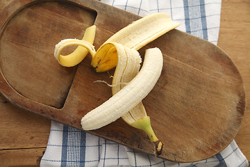 Image showing peeled banana on cutting board