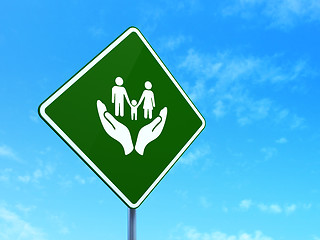Image showing Insurance concept: Family And Palm on road sign background