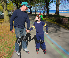 Image showing Father son rollerblade