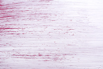 Image showing Rough brush strokes of white paint over pink