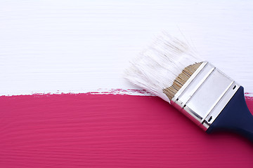 Image showing Painting pink surface with white paint