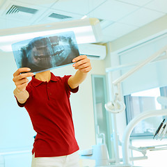 Image showing doctor or dentist looking at x-ray