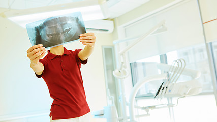 Image showing doctor or dentist looking at x-ray