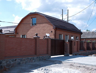 Image showing home and brick fence