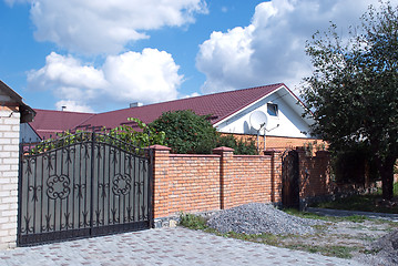 Image showing iron fence and a brick wall