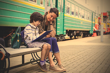 Image showing Mother and son on the railway station