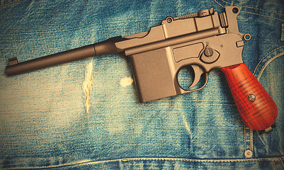 Image showing Mauser submachine gun on vintage jeans