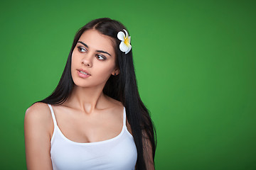 Image showing Teen female with Plumeria Flower