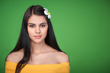 Image showing Teen female with Plumeria Flower