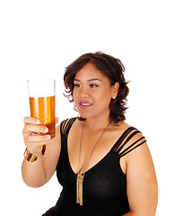 Image showing Pretty girl holding up glass of tee.