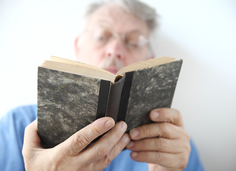 Image showing older man reads book 