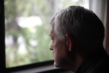 Image showing sad senior by a window