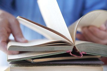 Image showing Man looks at a book. 