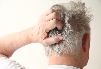 Image showing senior man scratching head 