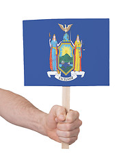 Image showing Hand holding small card - Flag of New York