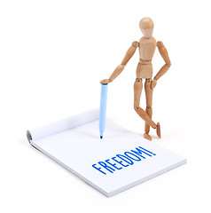Image showing Wooden mannequin writing - Freedom