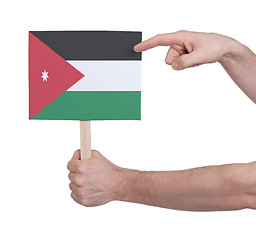 Image showing Hand holding small card - Flag of Jordan