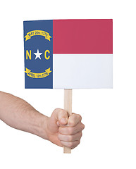 Image showing Hand holding small card - Flag of North Carolina