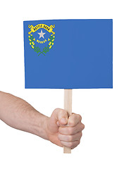 Image showing Hand holding small card - Flag of Nevada