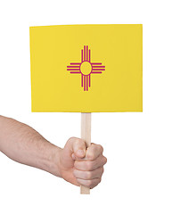 Image showing Hand holding small card - Flag of New Mexico