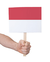 Image showing Hand holding small card - Flag of Monaco