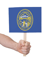 Image showing Hand holding small card - Flag of Nebraska