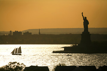 Image showing Boat sailing next to Liberty Statue