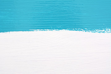 Image showing Stripe of teal paint over white wooden background