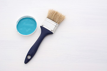 Image showing Clean paintbrush and blue paint on white board