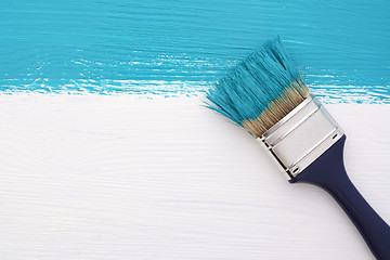 Image showing Stripe of turquoise paint with a paintbrush on white