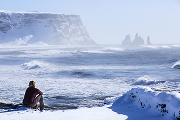 Image showing Woman enjoys view o three pinnacles of Vik, Iceland