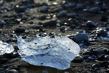 Image showing Ice block on black sand beach at glacier lagoon Jokulsarlon, Ice