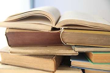 Image showing open book on top of stacks