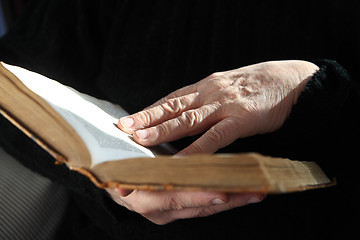 Image showing senior reader hands with old book 