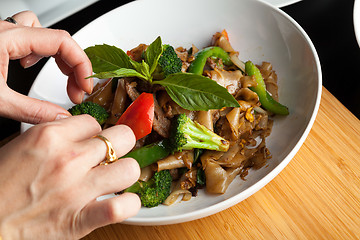 Image showing Food Stylist Garnishing a Dish