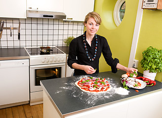 Image showing Young Female Making Pizza