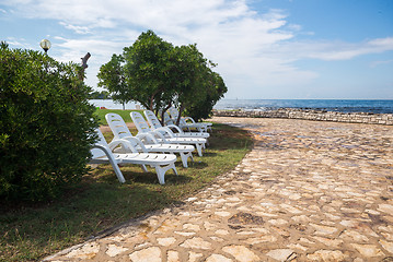 Image showing loungers on the rocky beach