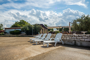 Image showing loungers on the rocky beach