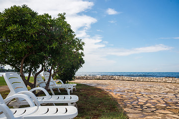 Image showing loungers on the rocky beach