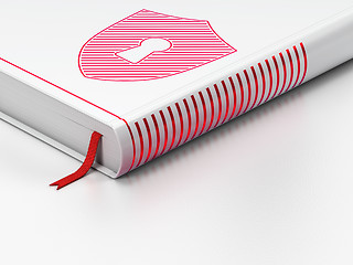 Image showing Safety concept: closed book, Shield With Keyhole on white background