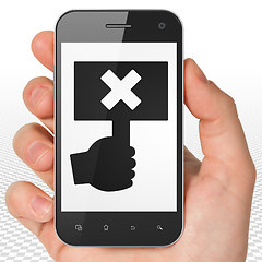 Image showing Political concept: Hand Holding Smartphone with Protest on display
