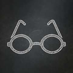 Image showing Studying concept: Glasses on chalkboard background