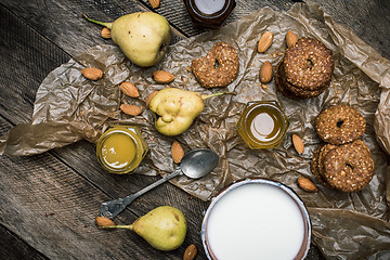 Image showing Almonds pears Cookies and joghrut on wood boards
