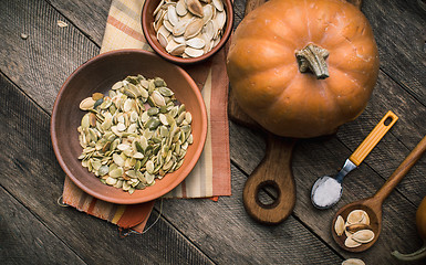 Image showing Rustic style pumpkins with seeds on wood