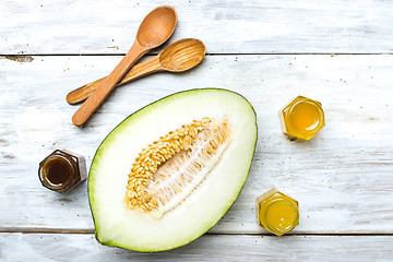 Image showing Healthy melon with honey on white board