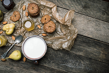 Image showing Tasty Pears almonds Cookies and joghurt on rustic wood