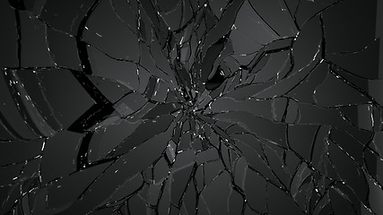 Image showing Cracked and broken glass on black